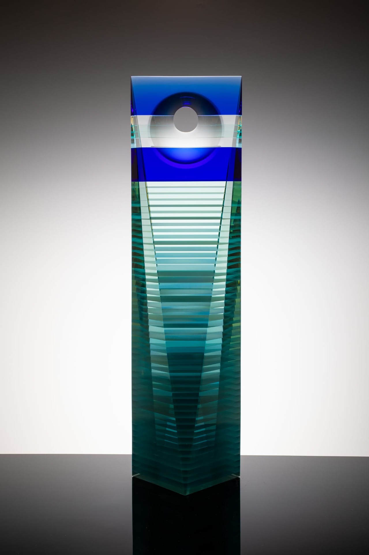 Contemporary glass sculptures by Wesley Neal Rasko exploring light, architectural form, and optical depth through layered geometric compositions